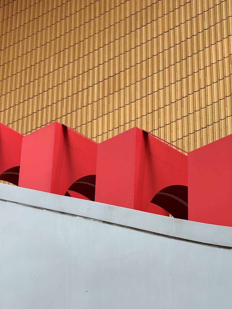 Dynamic abstract shot of geometric architecture with bold red and yellow tones.