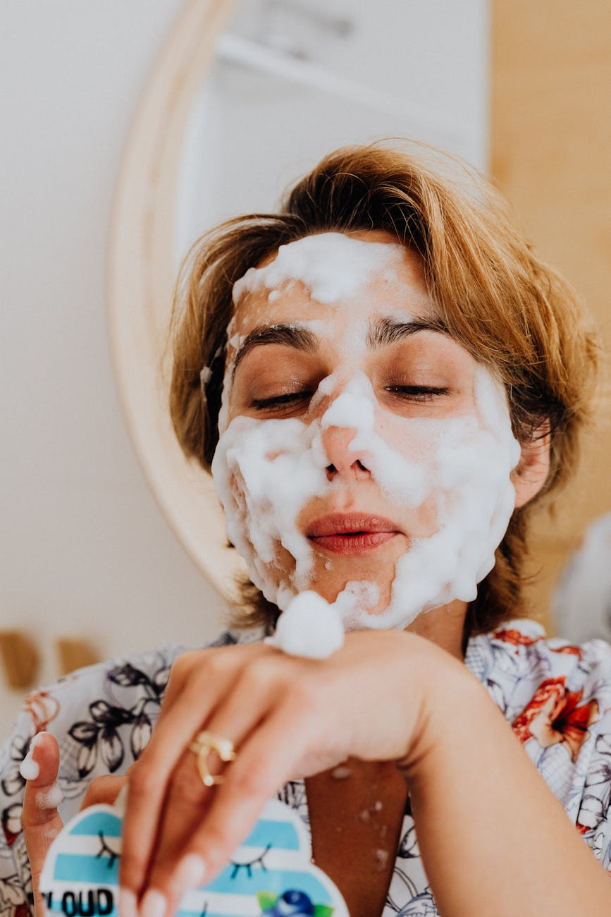 Woman enjoying a relaxing skincare routine with a foamy face mask for a fresh glow.