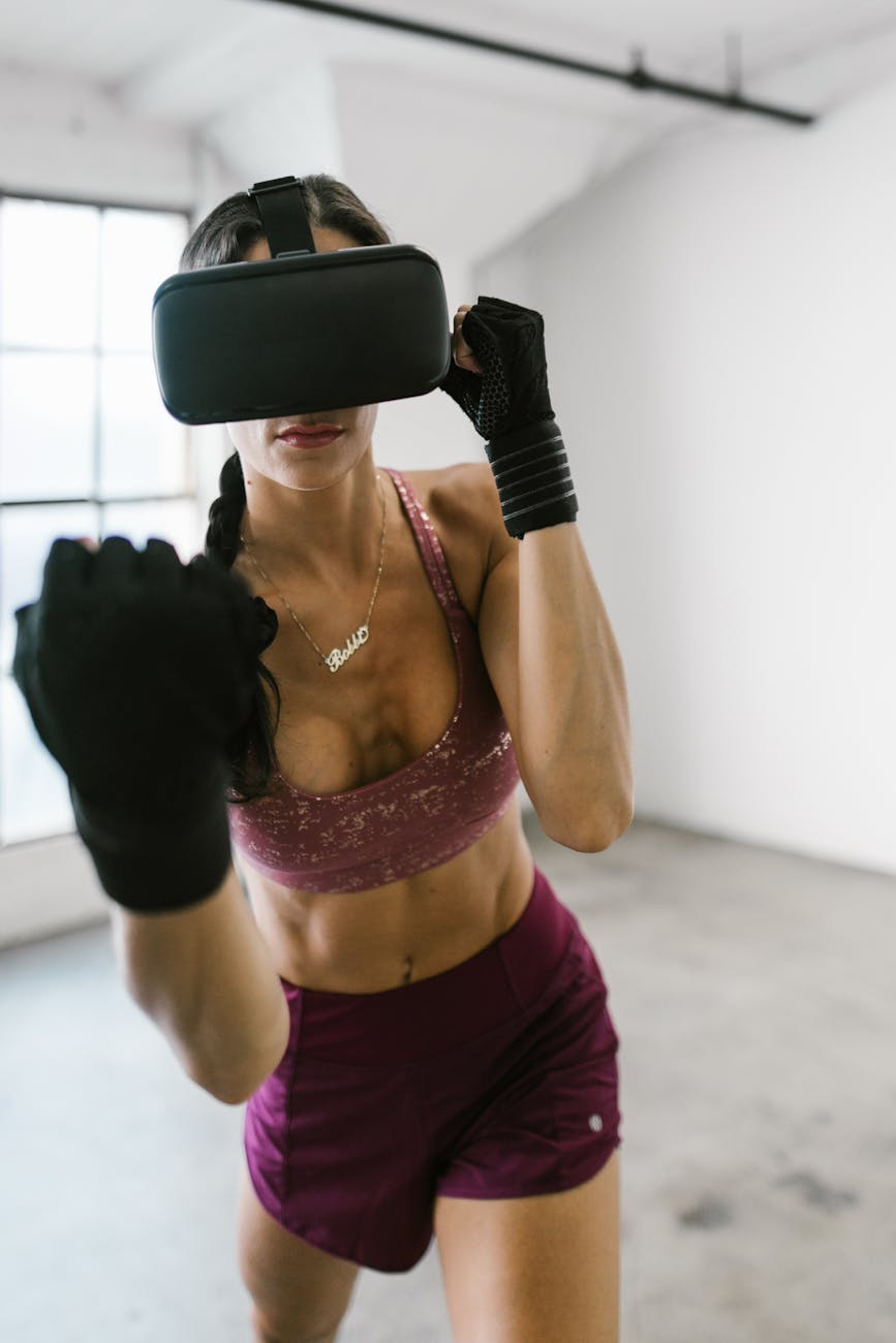 A woman engages in a fitness routine using a VR headset indoors, highlighting modern tech.