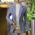 Chic tweed blazer showcased on a mannequin in a modern fashion store setting.